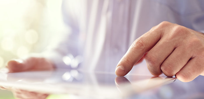 closeup of hand on tablet surface